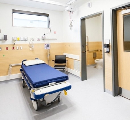 wide shot of a hospital room with a bathroom attached
